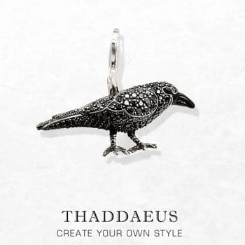 A Black Raven Pendant featuring intricate silver detailing and black stones, shown on a white background with the text THADDAEUS CREATE YOUR OWN STYLE beneath.