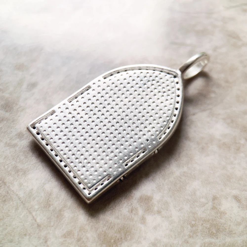 A Vintage Window Pendant shaped like a medieval arched door features engraved birds and shield details