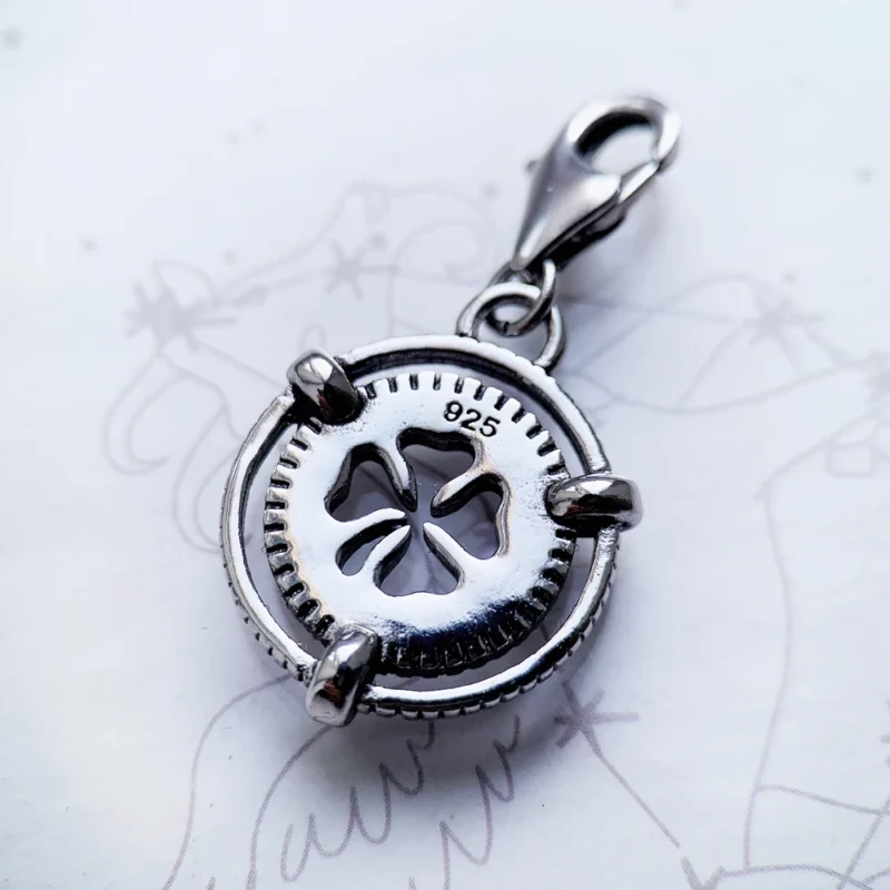 The Lucky Clover Dangle Charm Pendant features a silver clover cutout center and lobster clasp