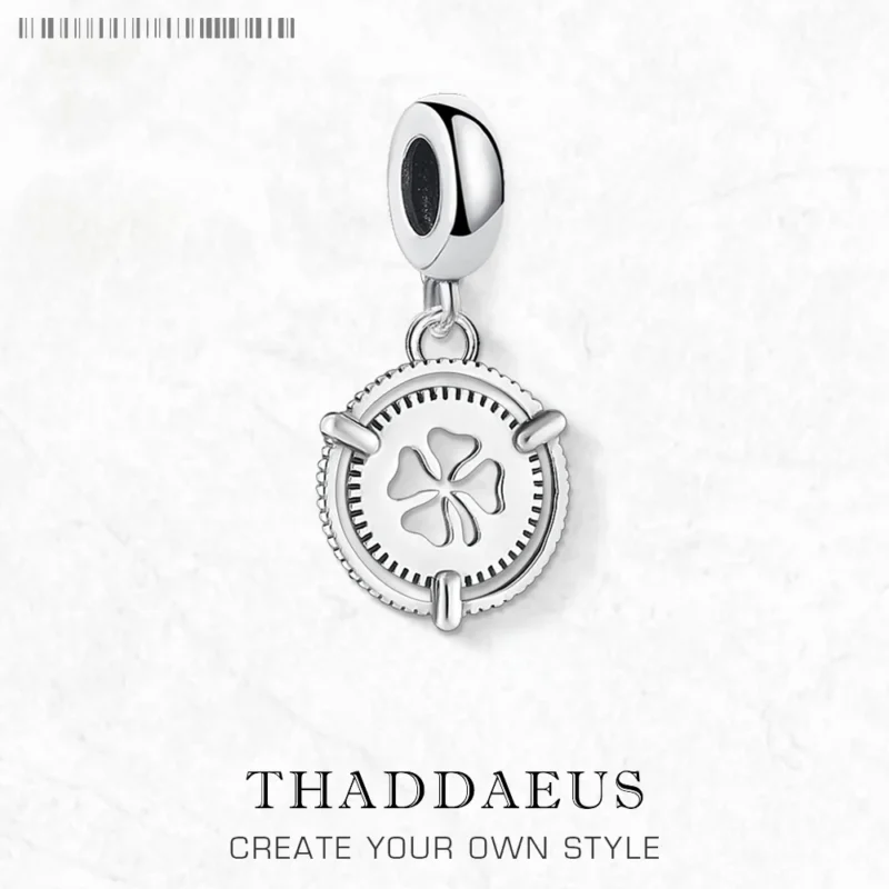 The Lucky Clover Dangle Charm Pendant features a silver clover cutout center and lobster clasp