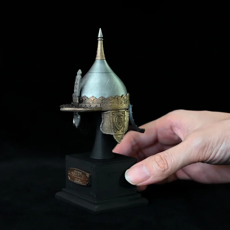 The Miniature Ancient Arabian Warrior Helmet features a pointed top and gold accents, displayed on a black pedestal with its full height marked as 135mm